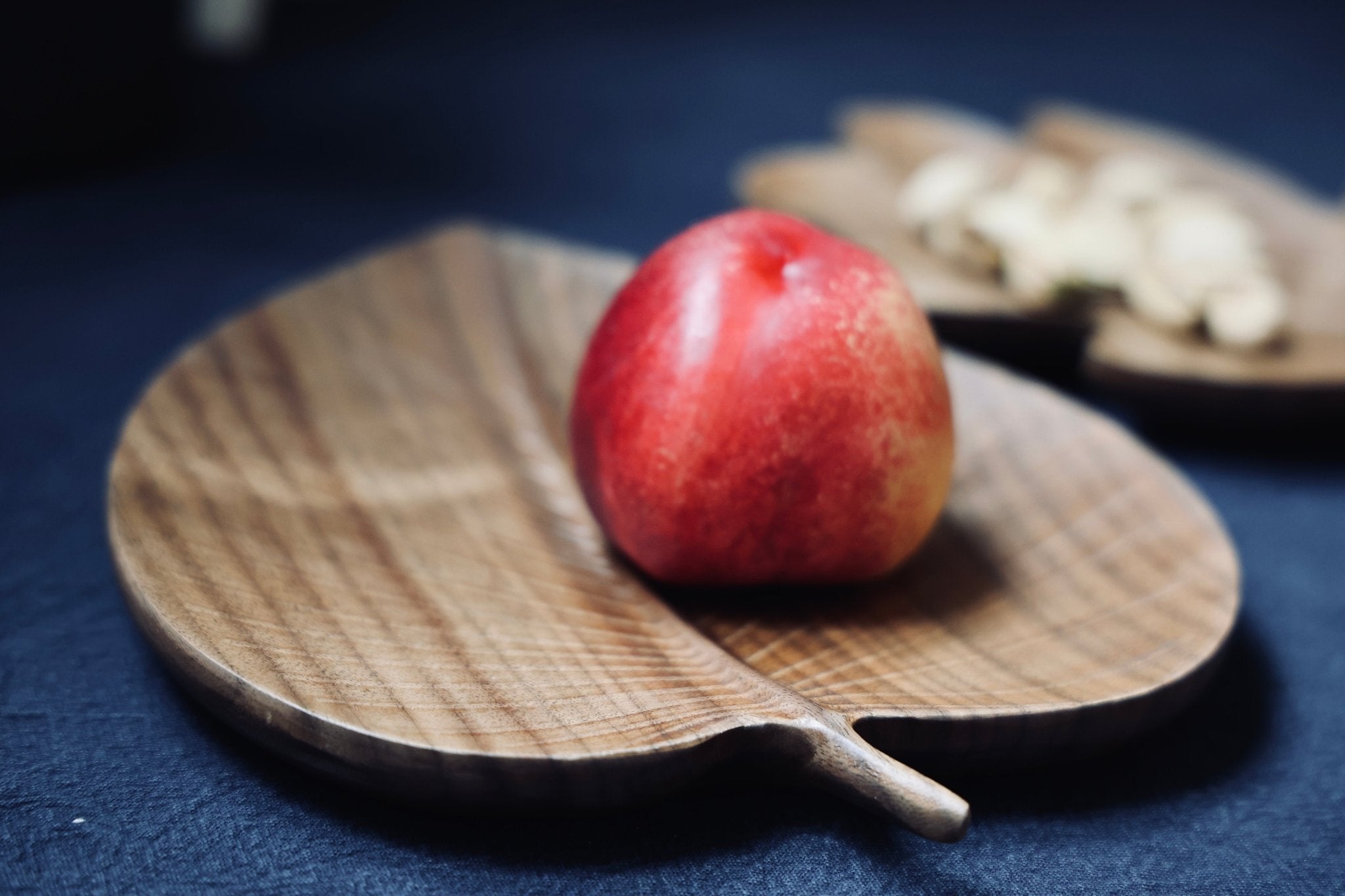 Black walnut tray on a pale cloth, its grain running the length of the board